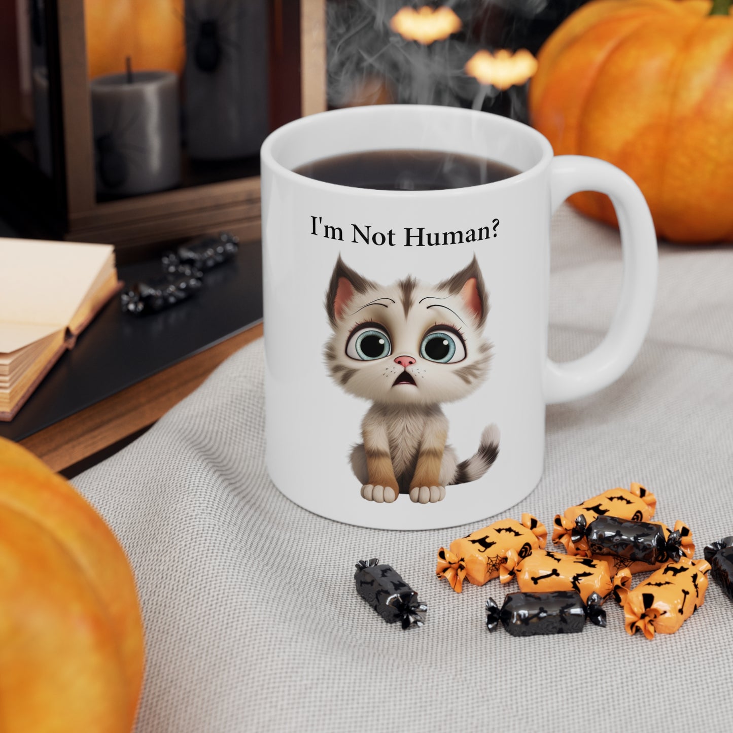 sad kitten graphic on coffee mug saying I'm not human?