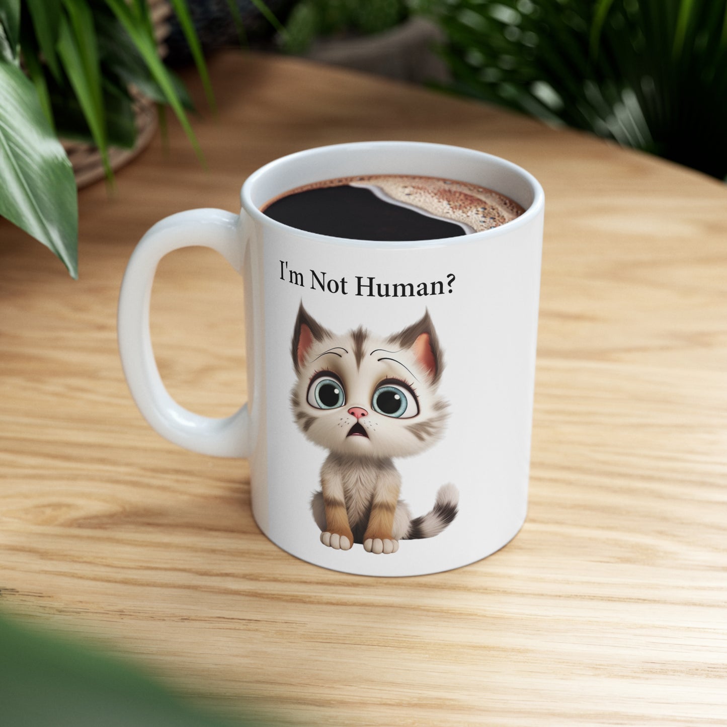 sad kitten graphic on coffee mug saying I'm not human?