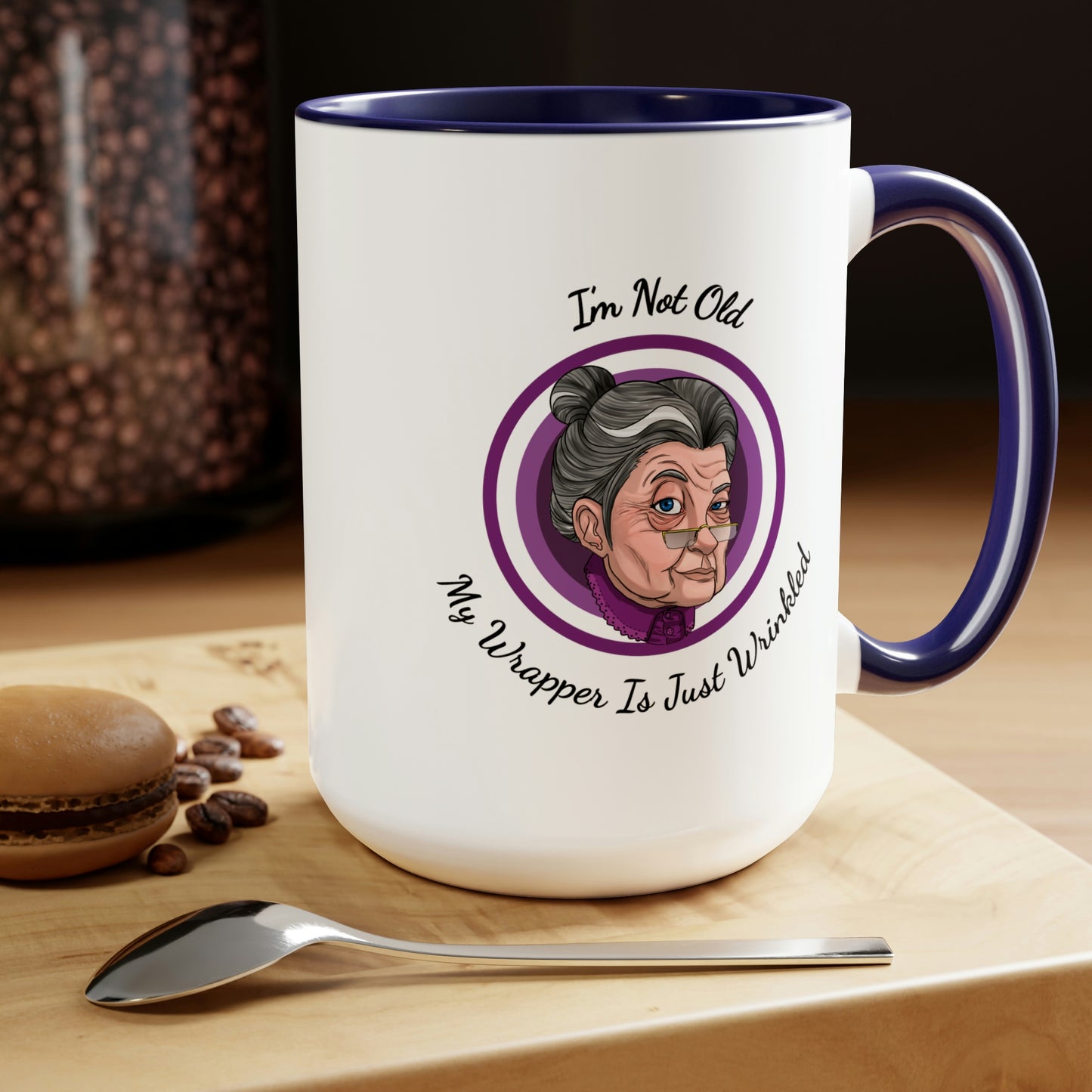 dark blue two tone coffee mug with purple logo saying I'm not old my wrapper is just wrinkled