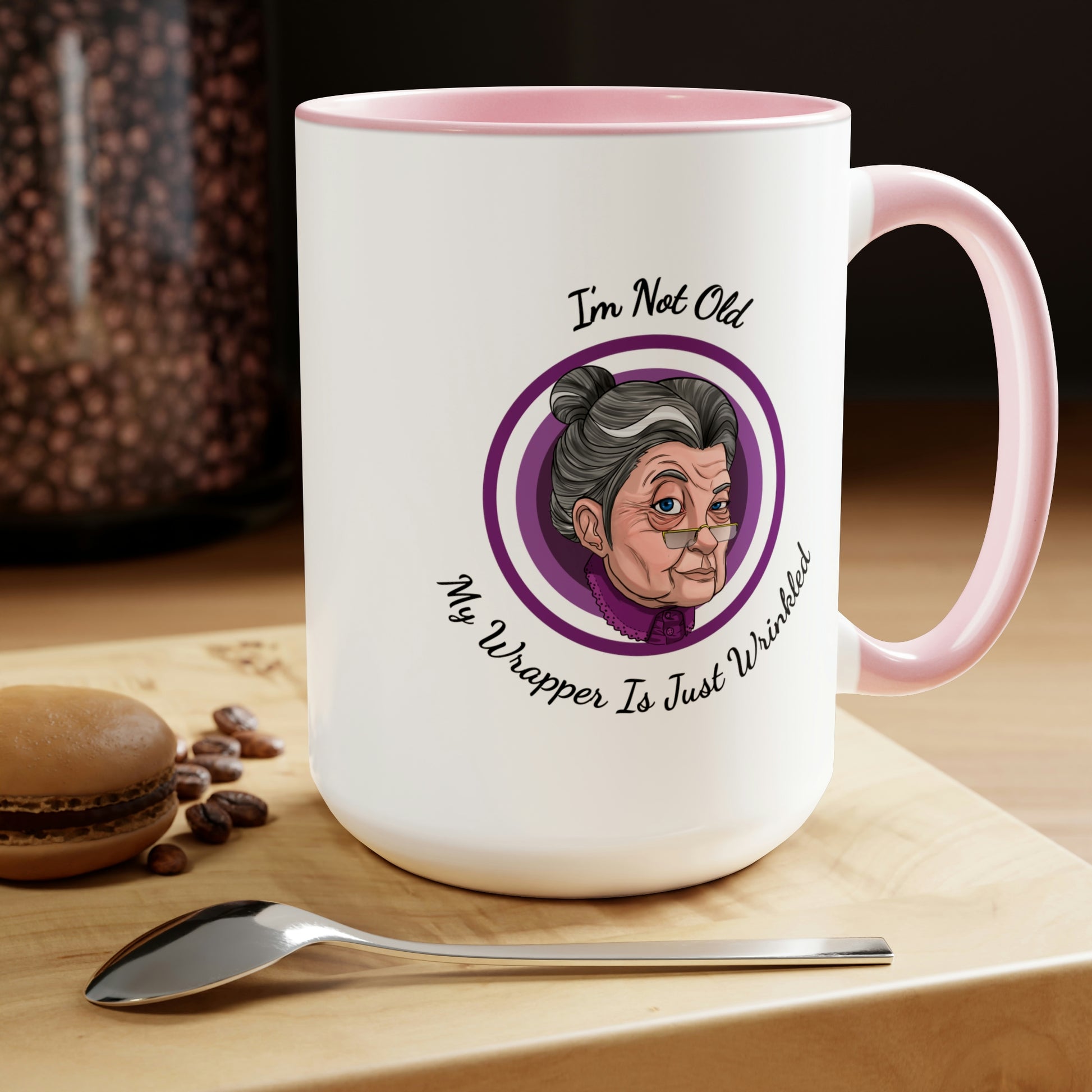 pink two tone coffee mug with purple logo saying I'm not old my wrapper is just wrinkled