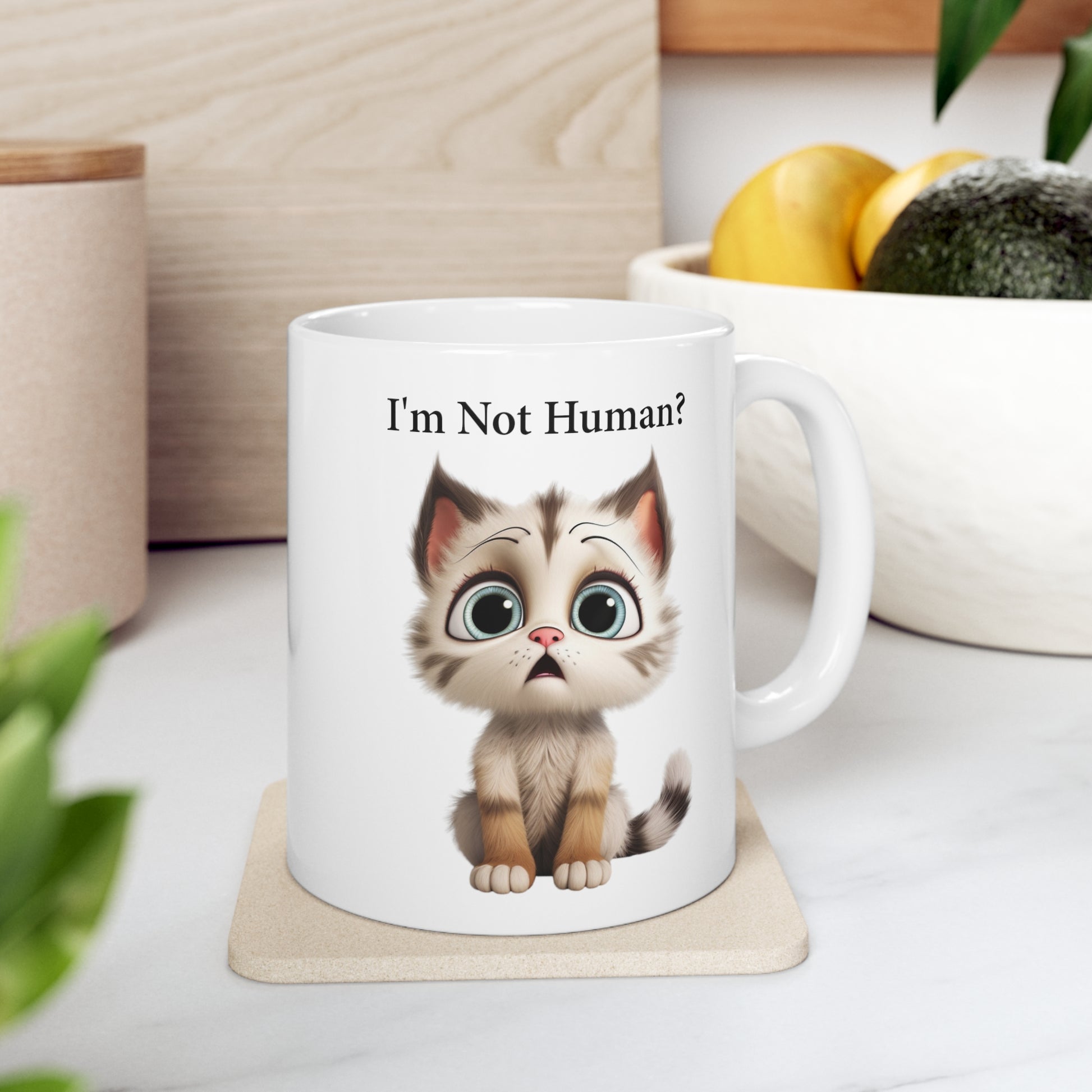 sad kitten graphic on coffee mug saying I'm not human?