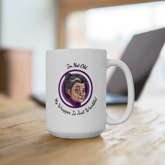 white 15oz coffee mug with purple logo saying I'm not old my wrapper is just wrinkled